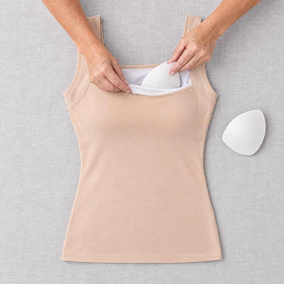 Hands slipping a soft pad into the tank's inner lining
