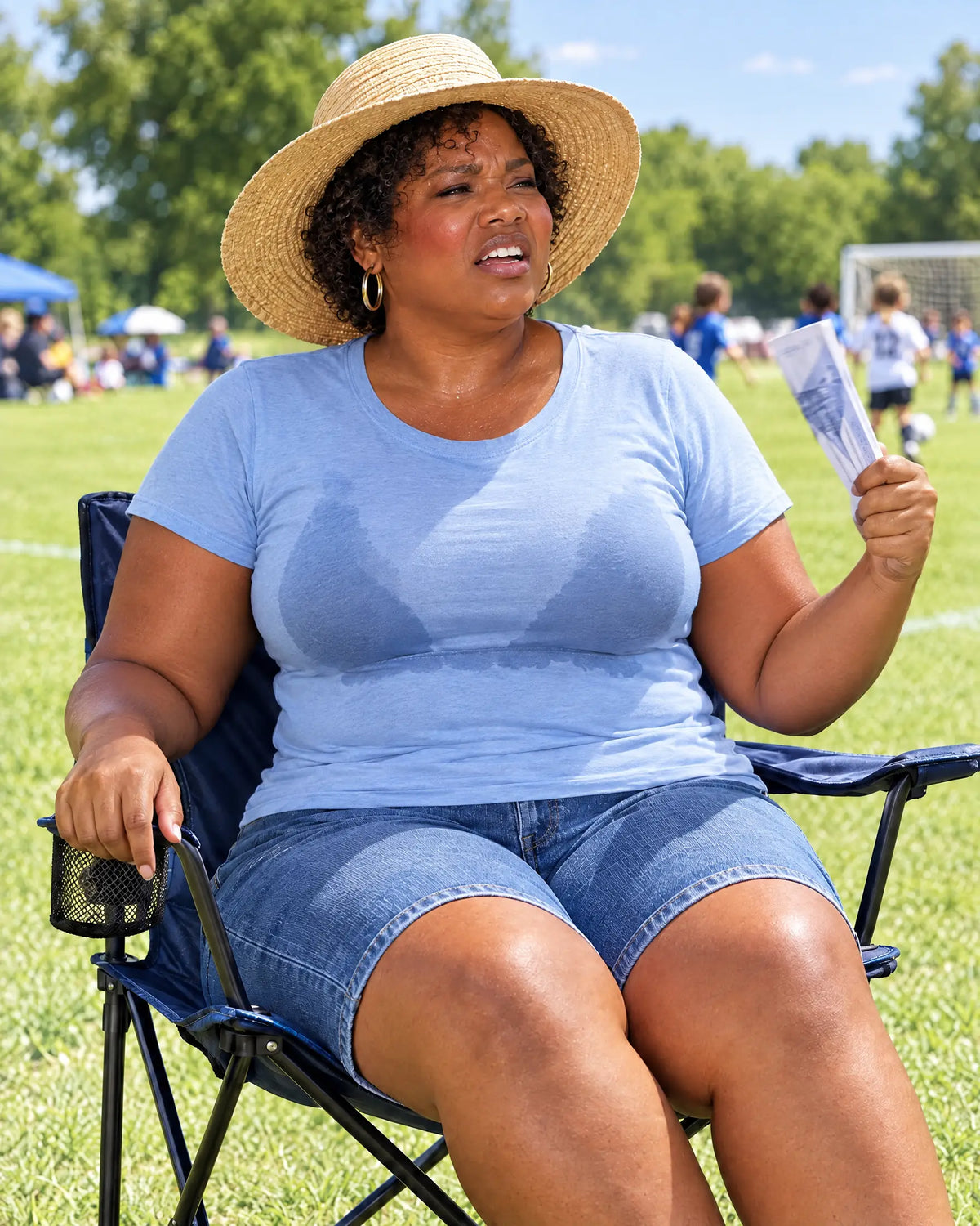 At a kids' soccer game in a bra and T-shirt: sweaty and fanning herself