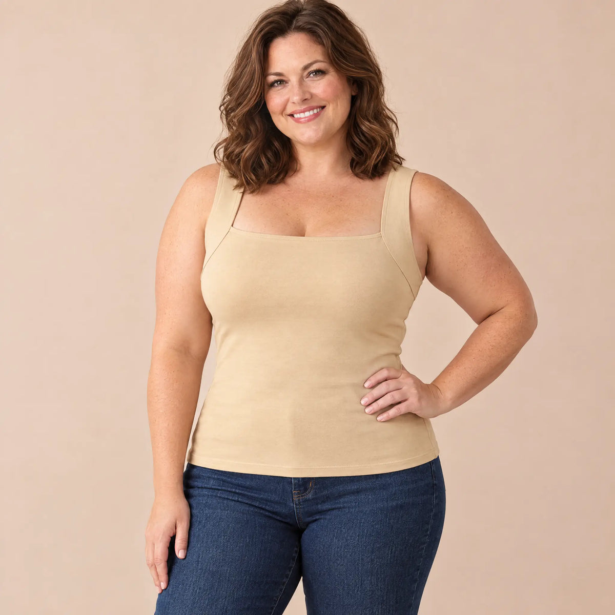 Curvy woman in her 40s wearing the SmartFit bra tank in Nude with jeans