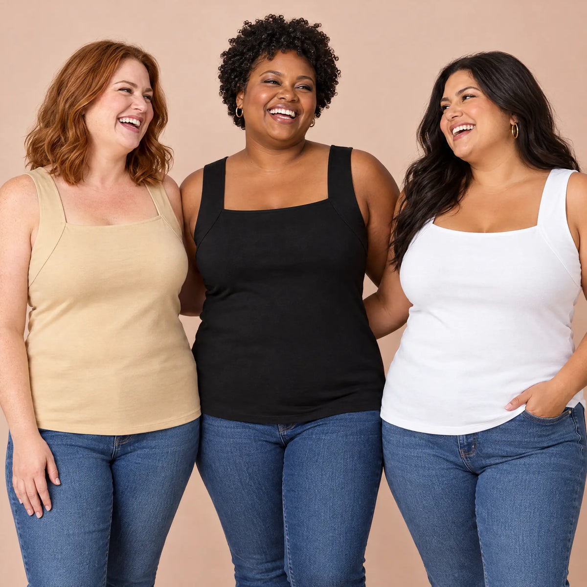 Three curvy women laughing together in the Beige, Black and White bra tanks